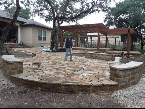 Circular flagstone patio with stone seat walls and pergola